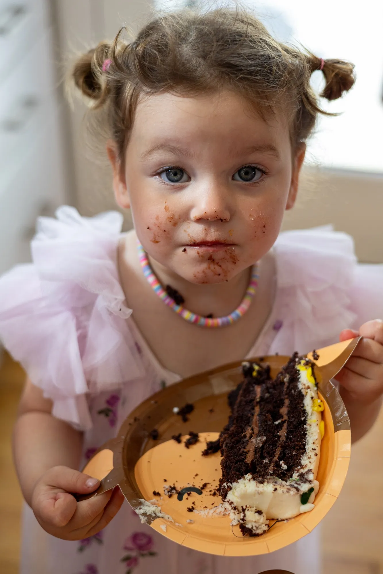 A child celebrates a birthday with a cake.