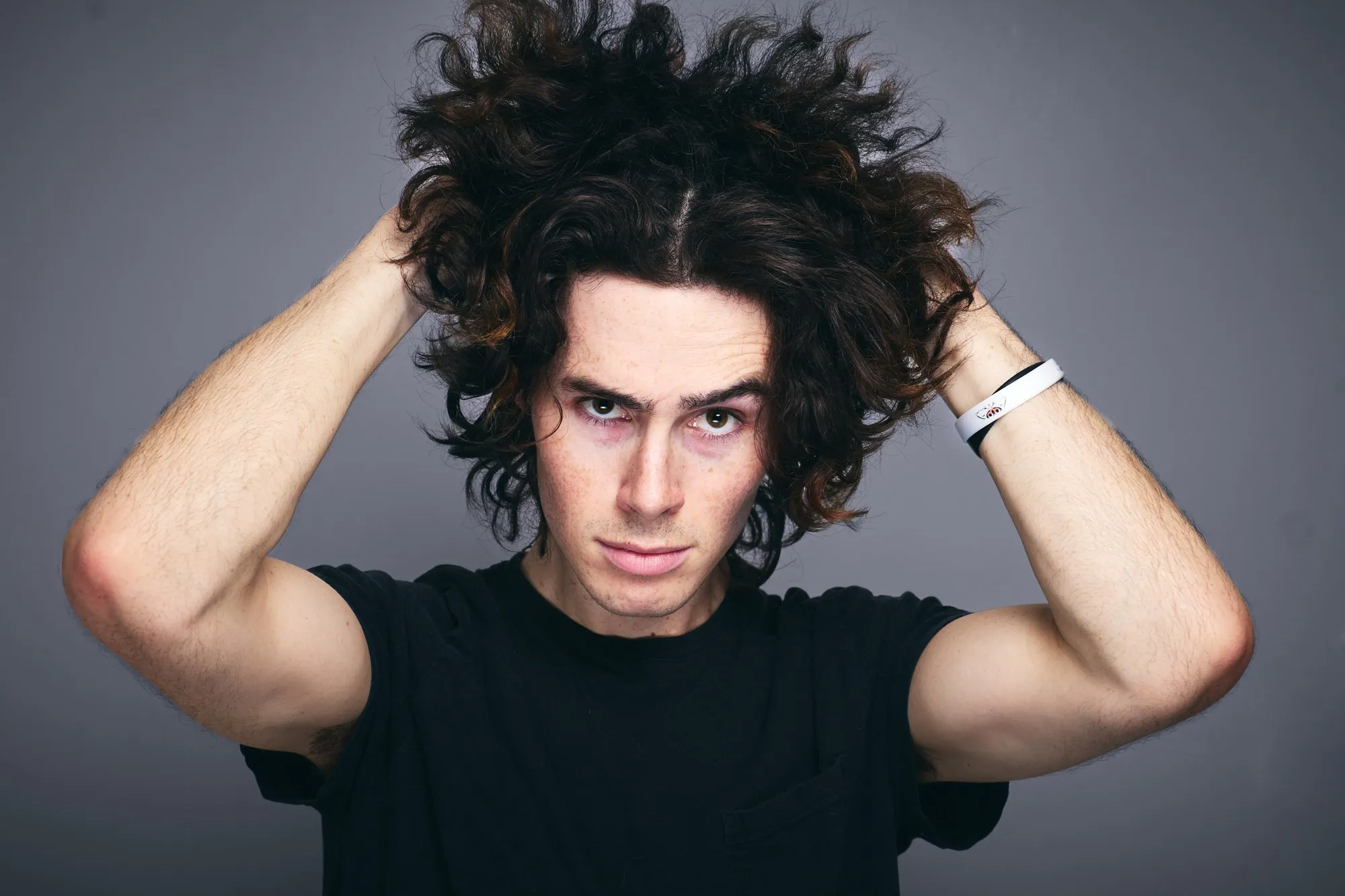 Kyle poses against a dark studio backdrop.