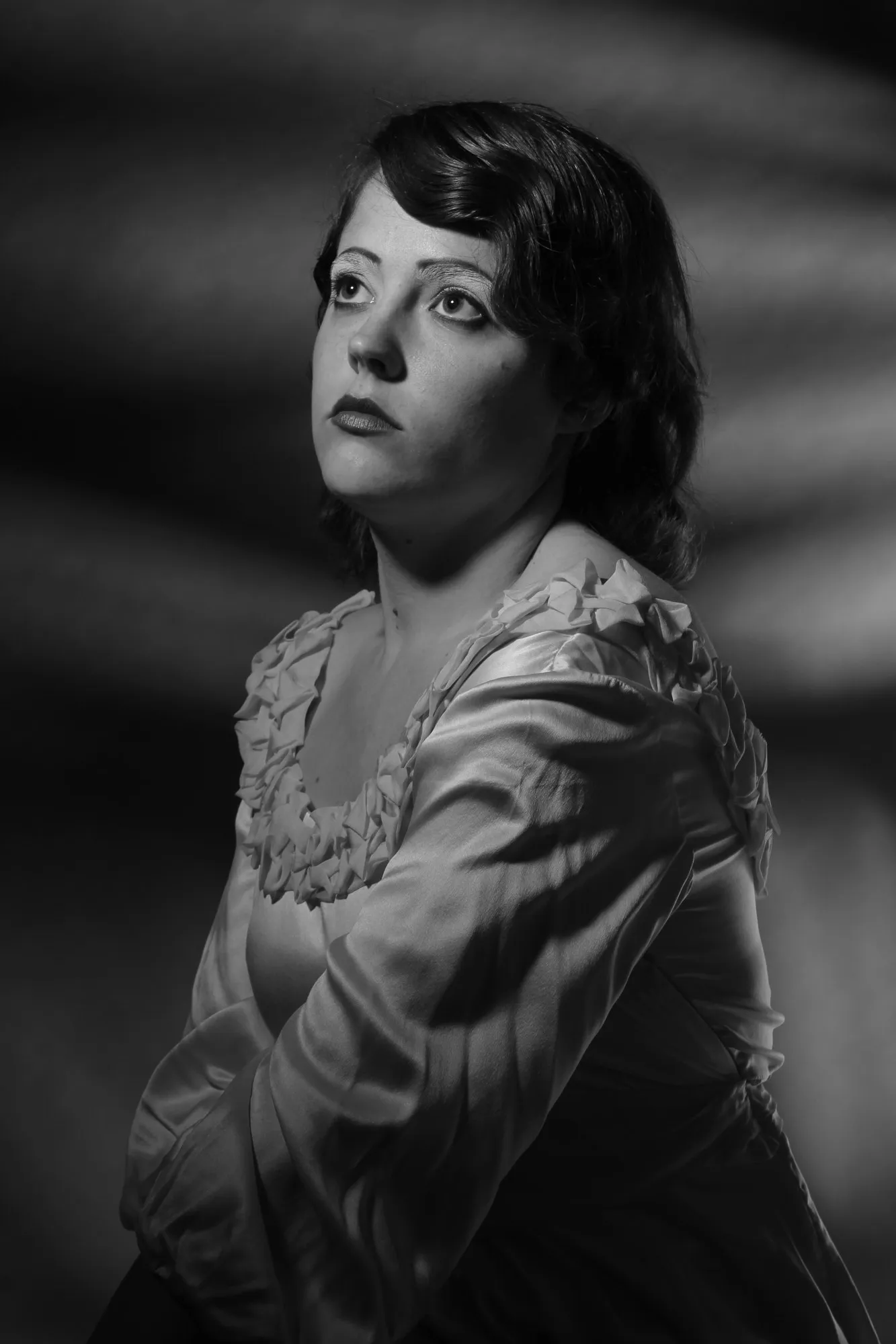 A black-and-white portrait of Lulu looking upward.