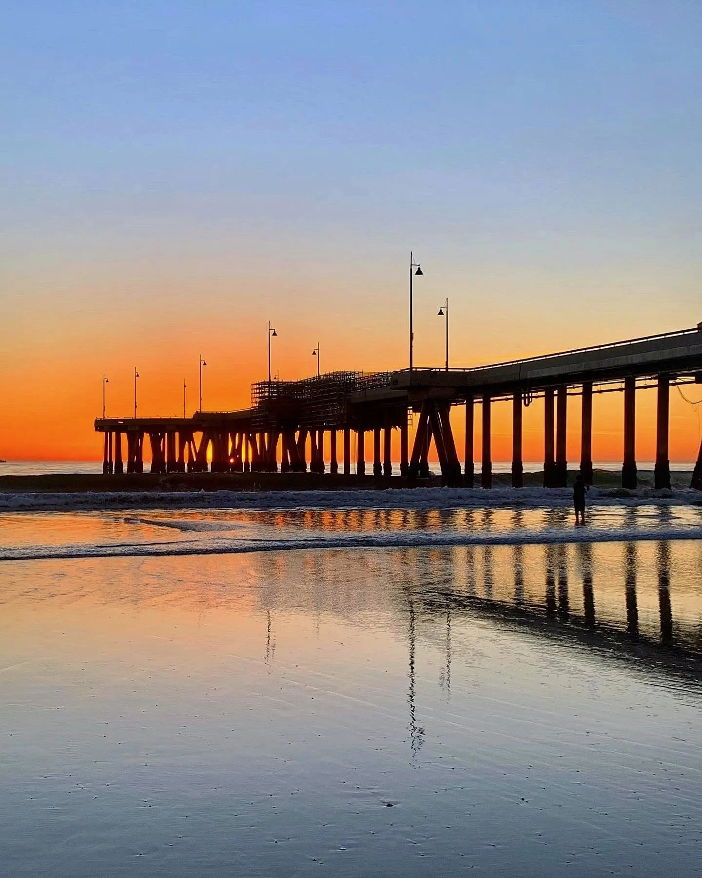 The pier mirrored at dusk. A beach observation made in the changing evening light.