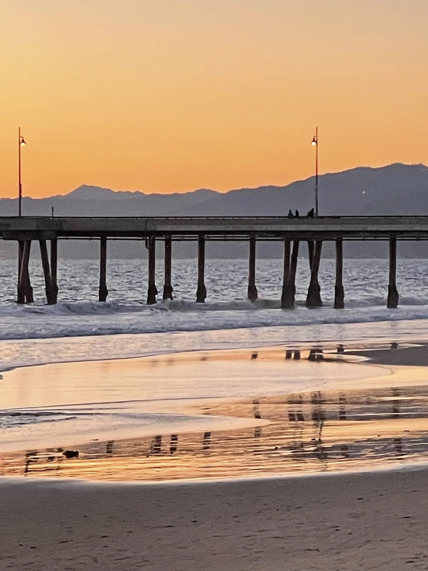 Pier stretching into the morning light. A beach observation made in the changing evening light.