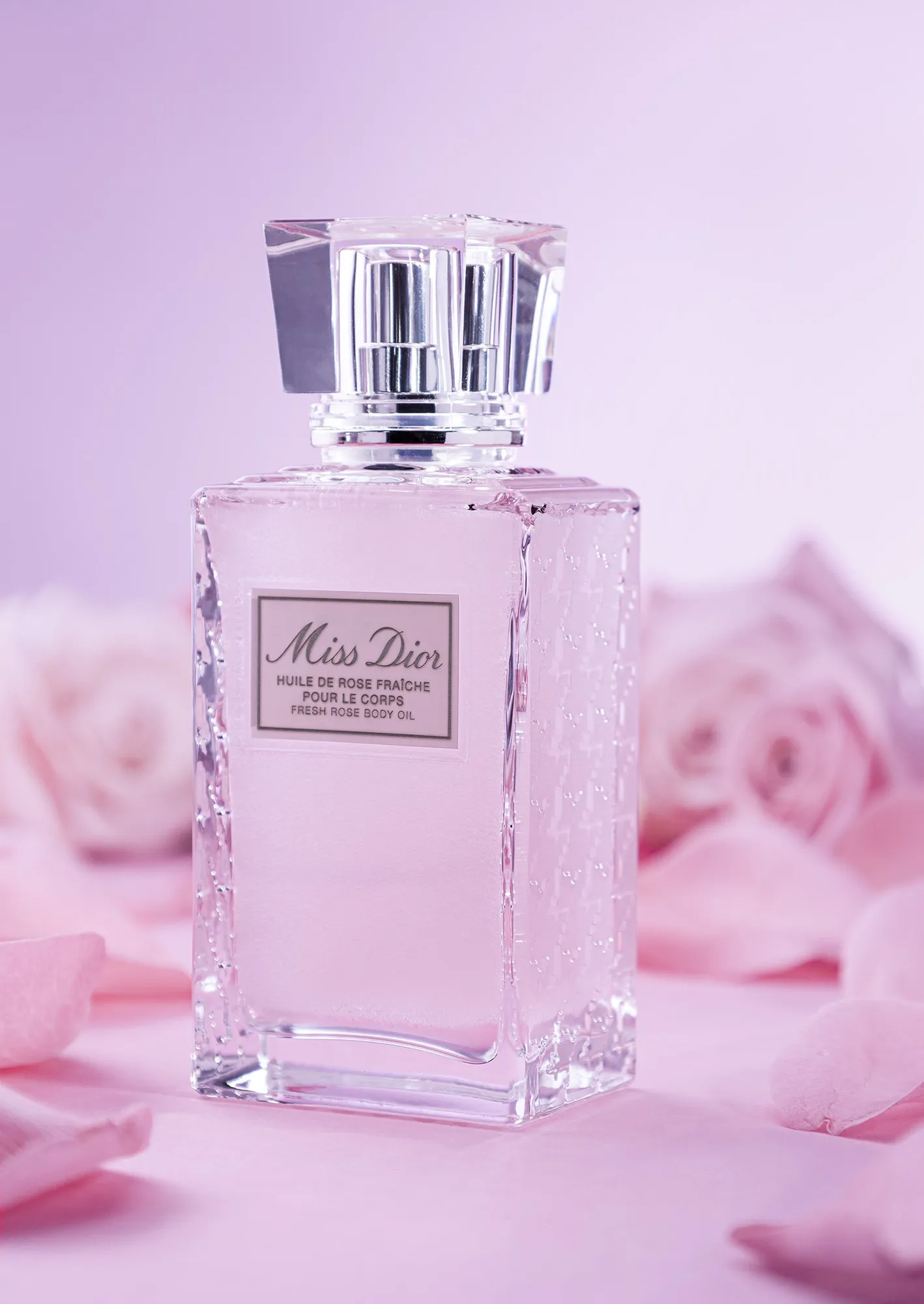 A pale perfume bottle in a soft pink composition
