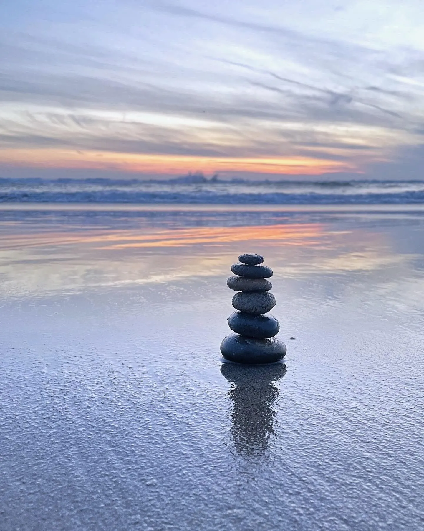A stack of stones beside the sea. A beach observation made in the changing evening light.