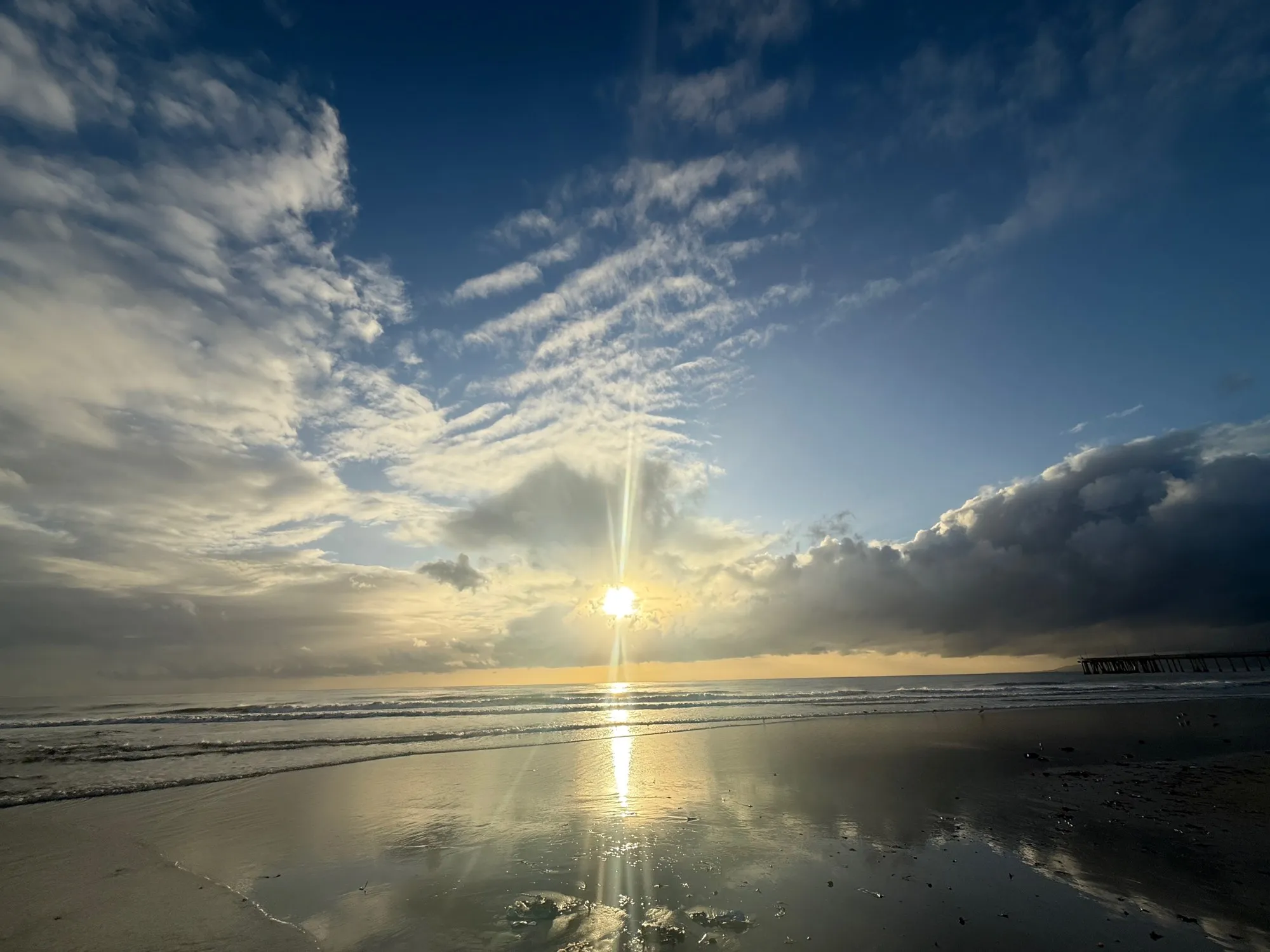 Sunlight breaks through the clouds. A beach observation made in the changing evening light.