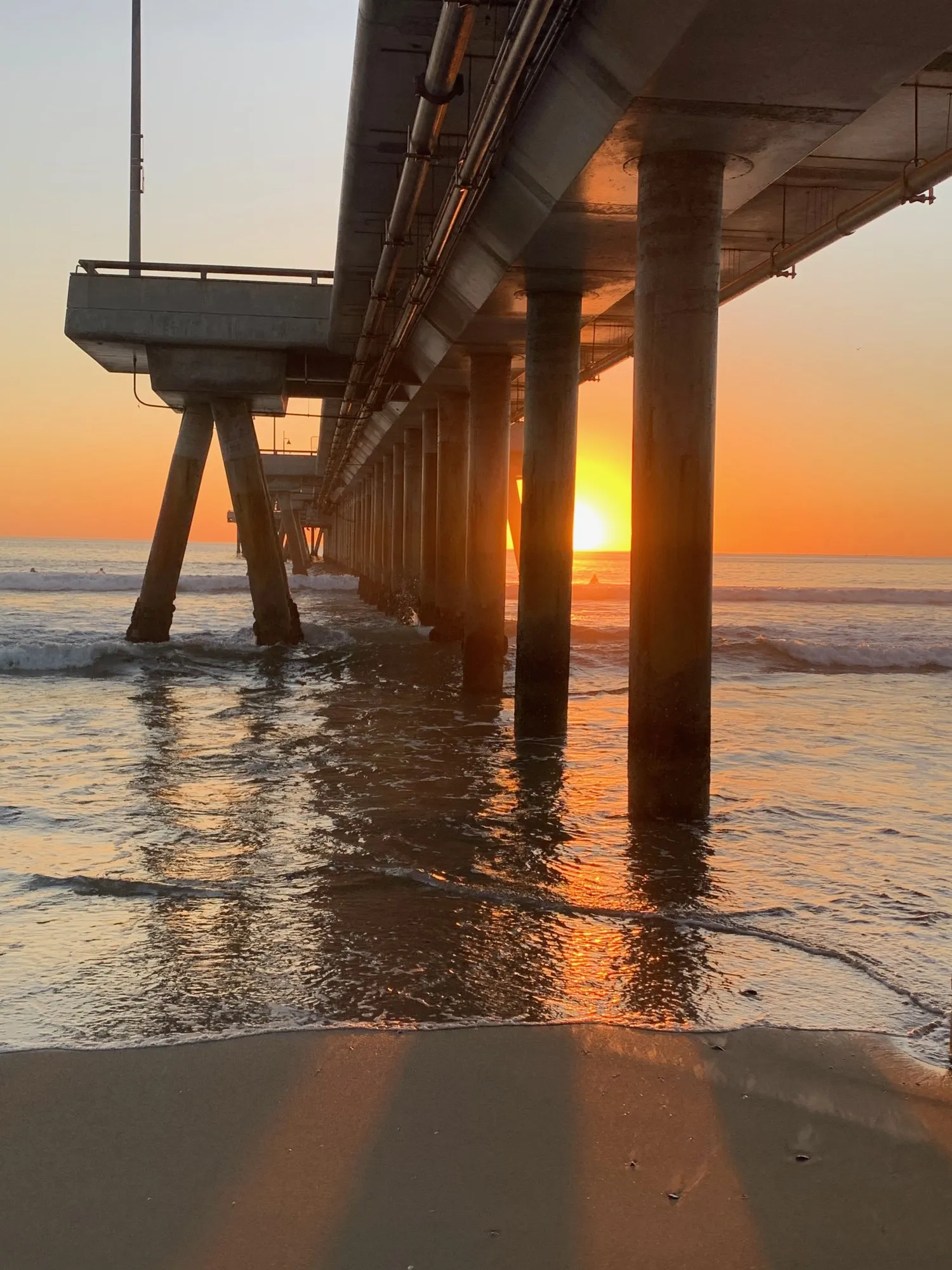 Sunlight under the pier. A beach observation made in the changing evening light.