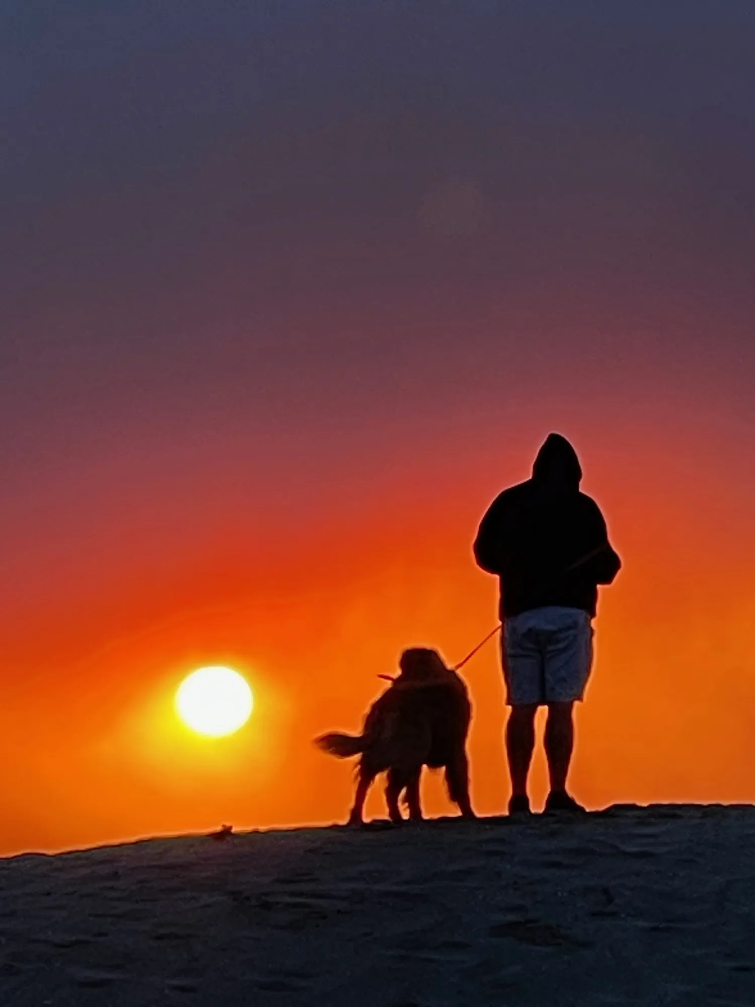 Two figures at sunset. A beach observation made in the changing evening light.