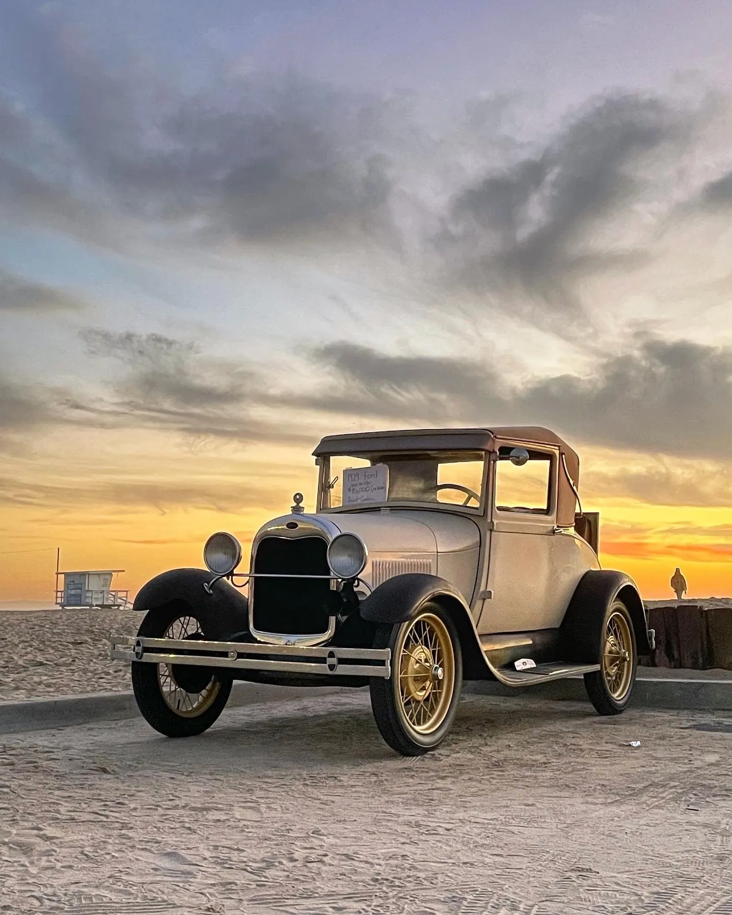 A vintage car on the beach. A beach observation made in the changing evening light.