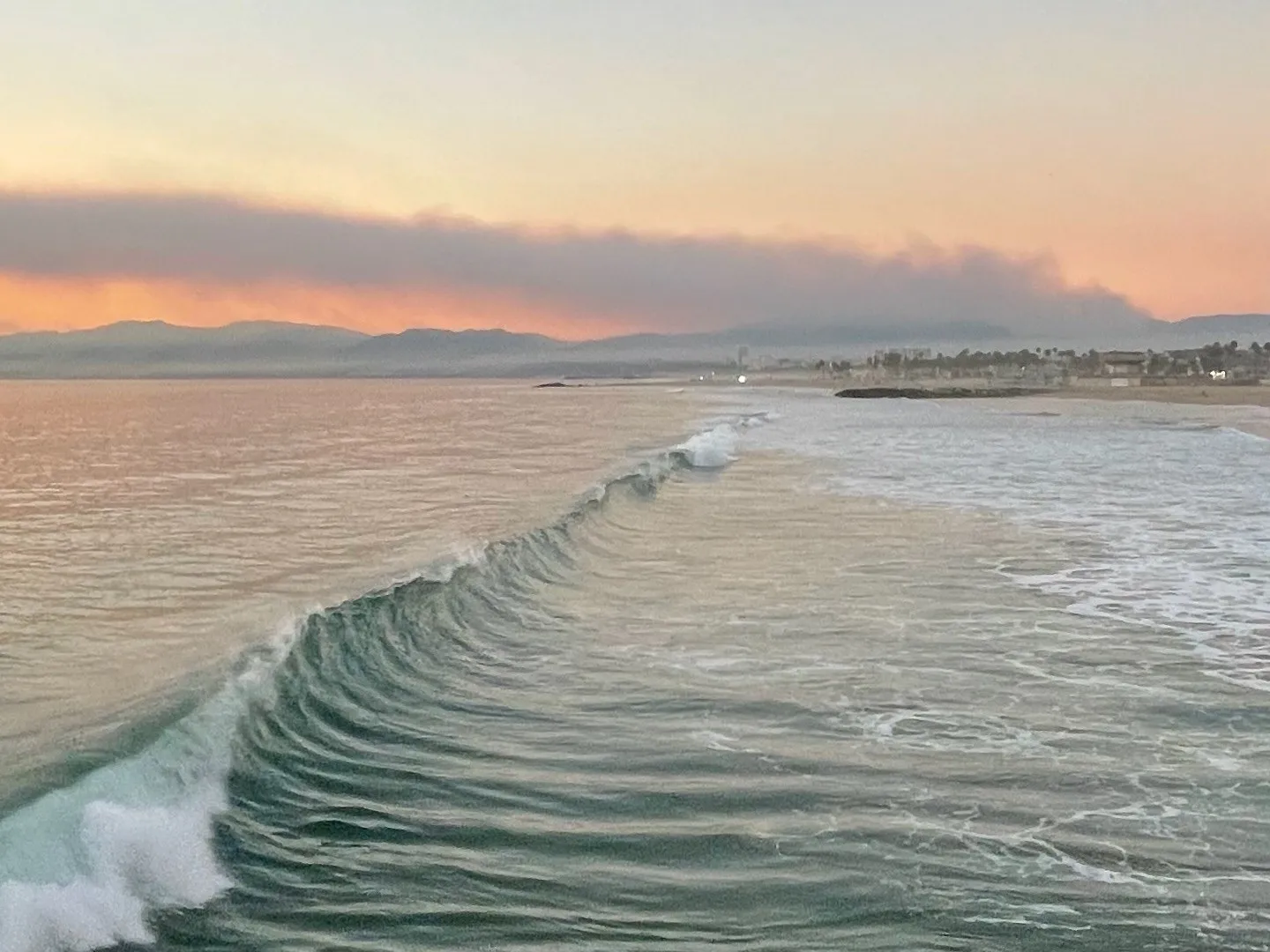 A wave folding onto the shore. A beach observation made in the changing evening light.